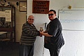 Stuart Clare is presented with his medal by Kevin